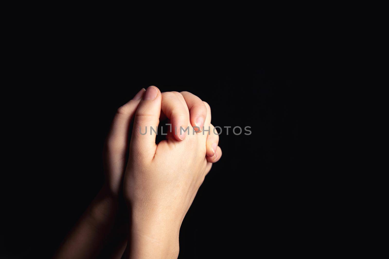 Praying hands with faith in religion and belief in God on blessing background. Power of hope or love and devotion in the dark with copy space , space for text