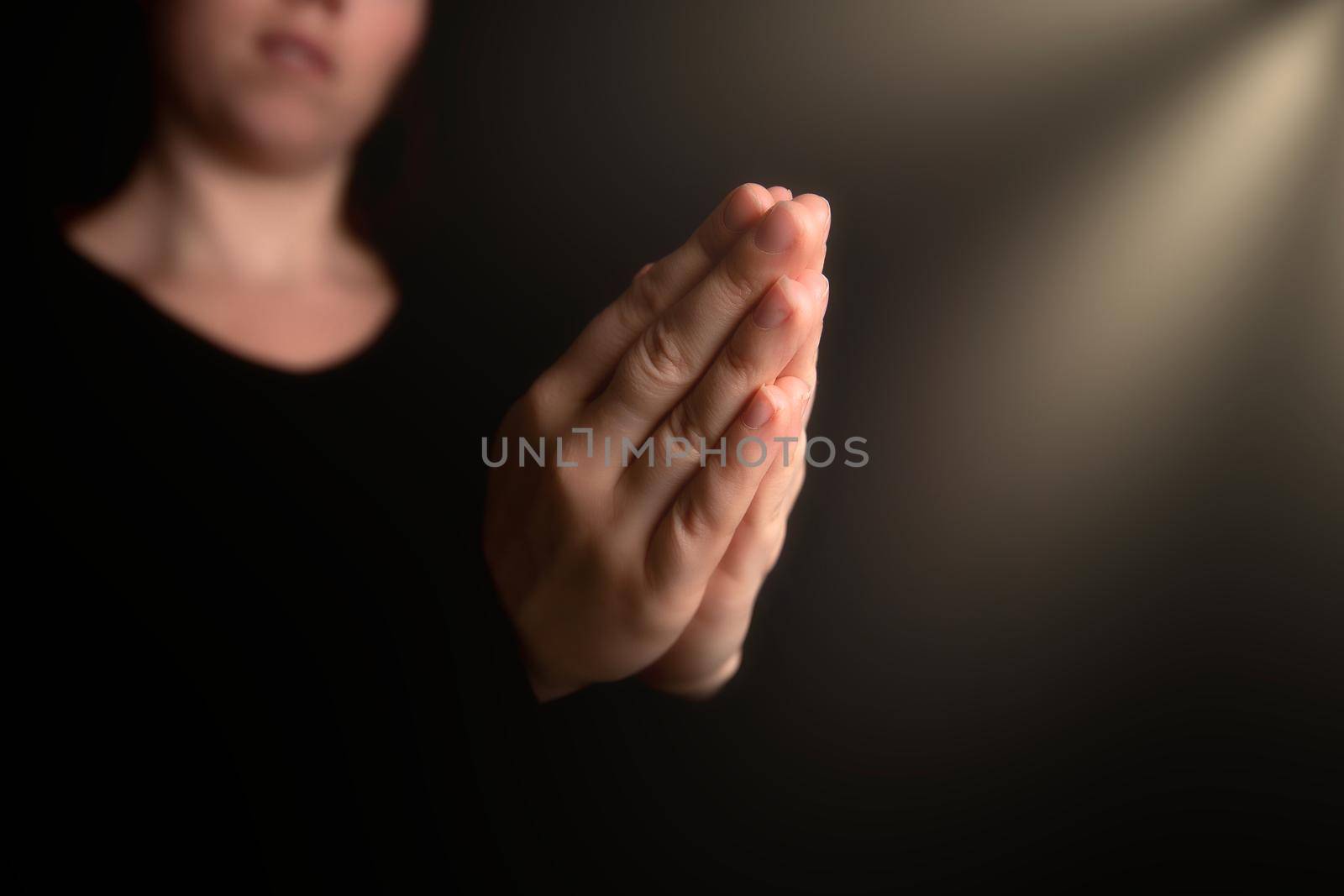 Praying hands with faith in religion and belief in God on blessing background. Power of hope or love and devotion in the dark with copy space , space for text