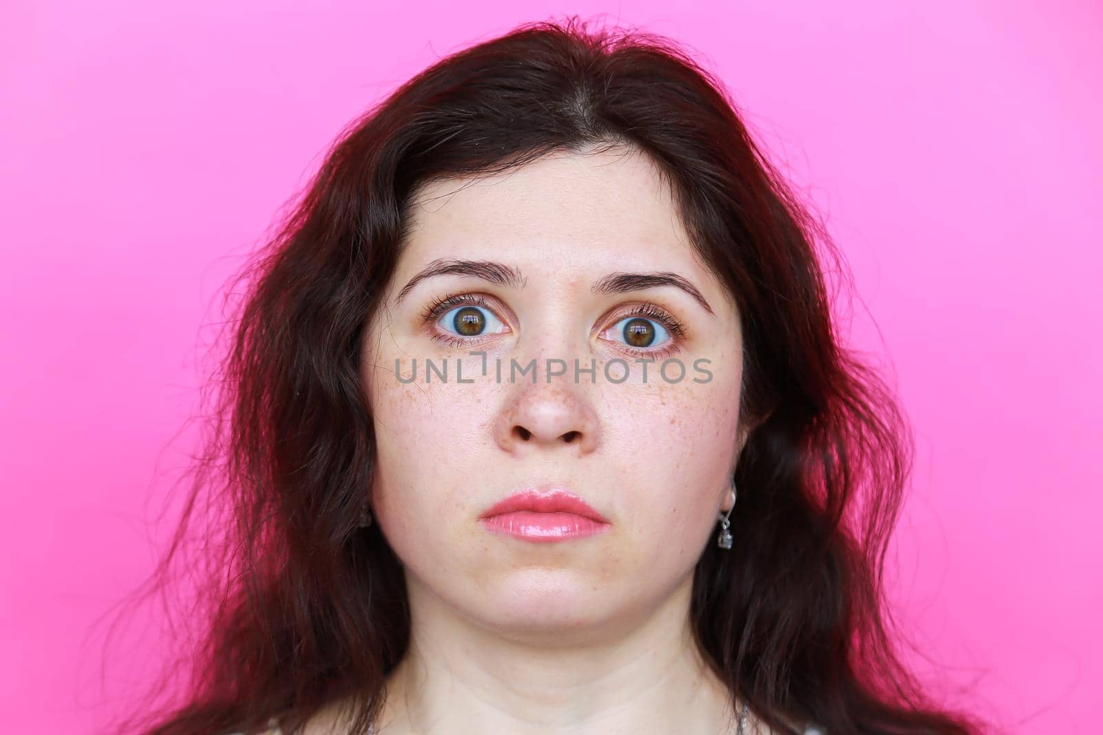 Surprised scared young woman on pink background by Satura86