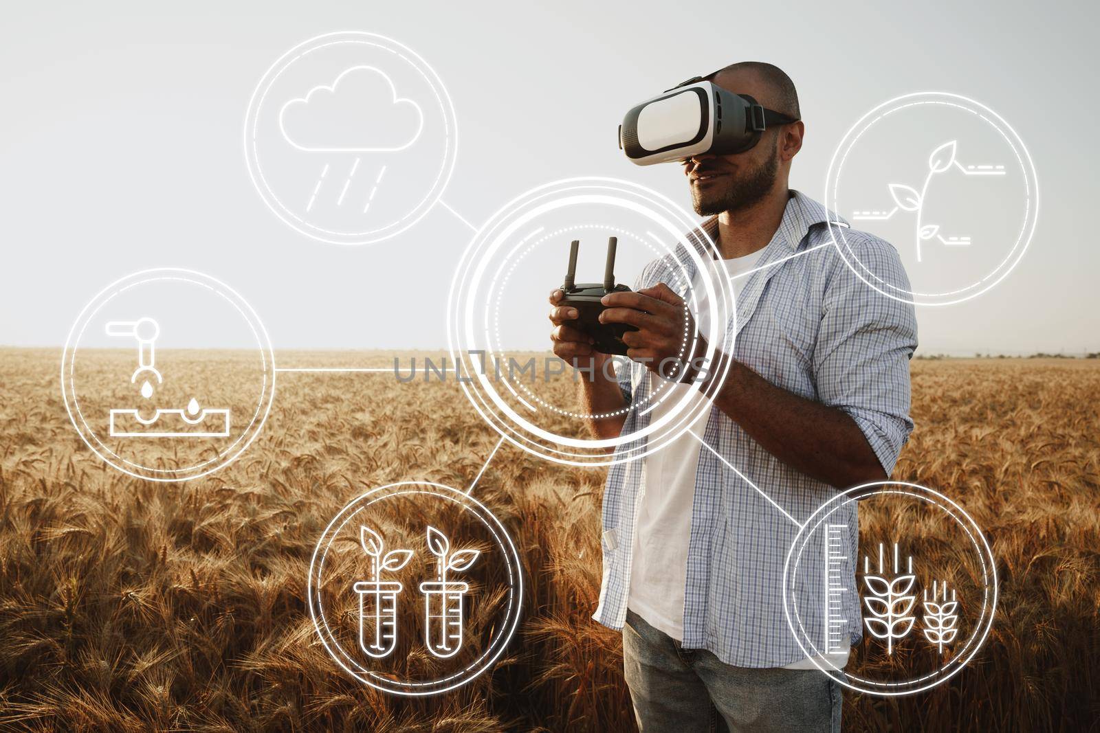 Man farmer standing in wheat field and controlling drone close up. Technologies in agriculture concept