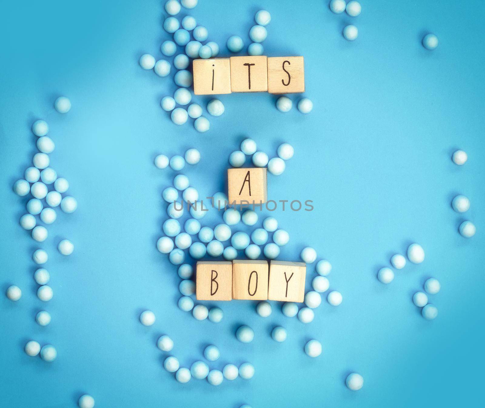 Its a Boy text written with wooden cubes with pastel blue background, Baby Shower or Nursery background Baby announcement. Flat lay,text space. top view copy space, modern concept
