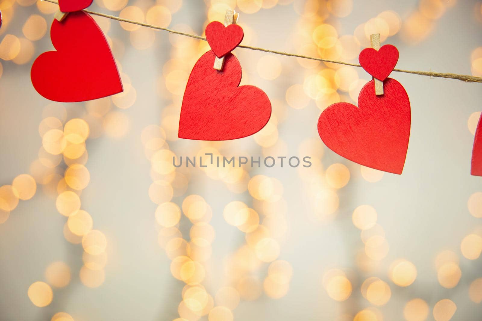 Happy Valentine day background with red hearts hang with clothespin on rope with bokeh background, romantic design, greeting card or copy space space for text