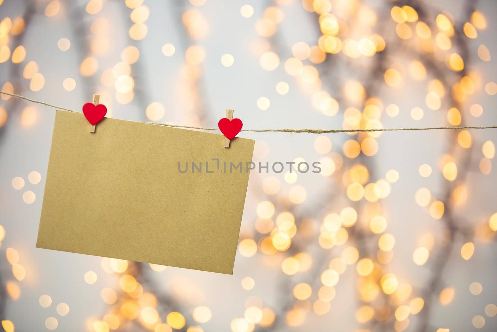 Blank letter, envelope or greeting card hanging with red hearts, romantic love letter , Valentines Day concept bokeh background, copy space romantic design
