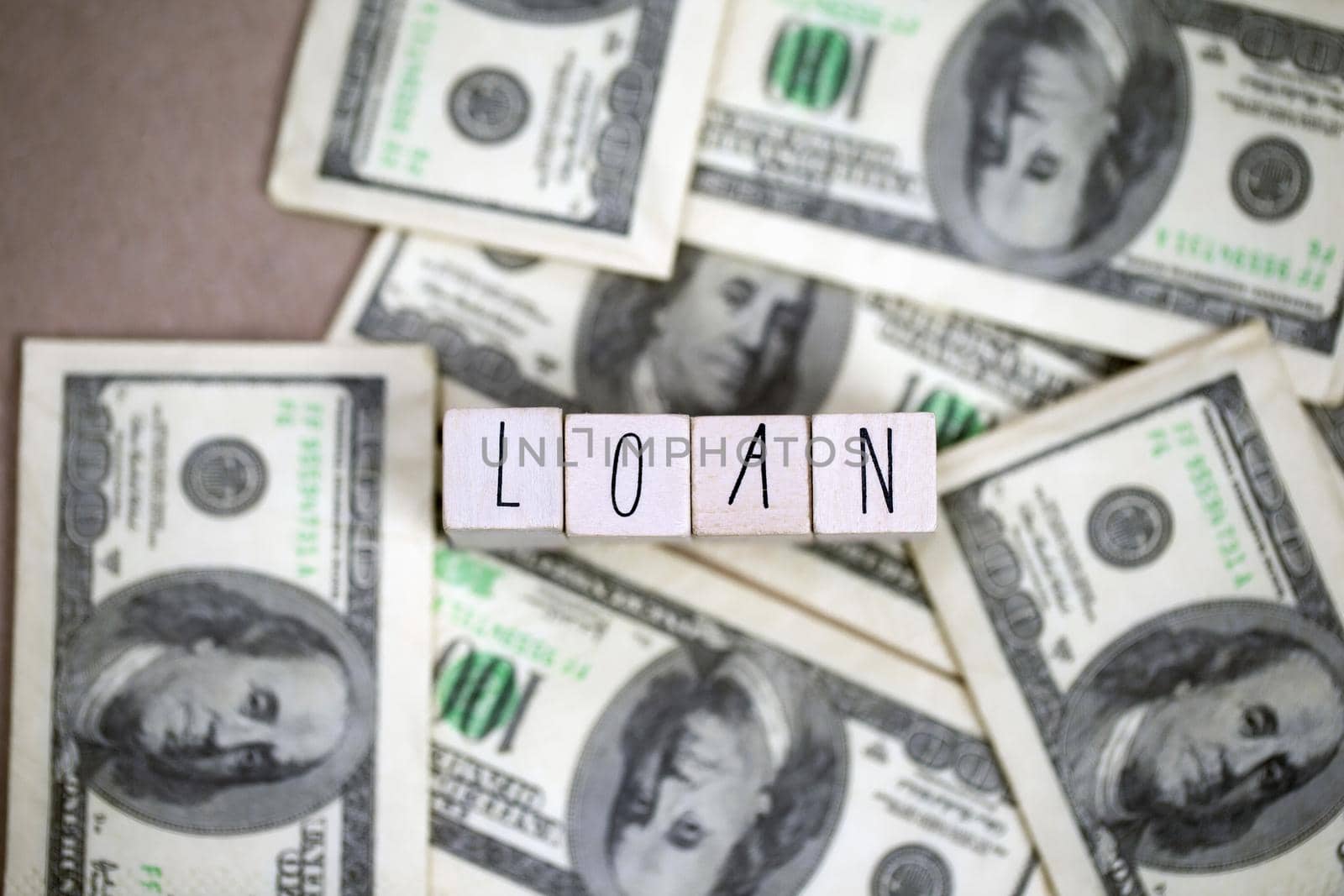 Word Loan with hundred dollar bills, business and finance concept, for mortgage or business background, copy space, space for text