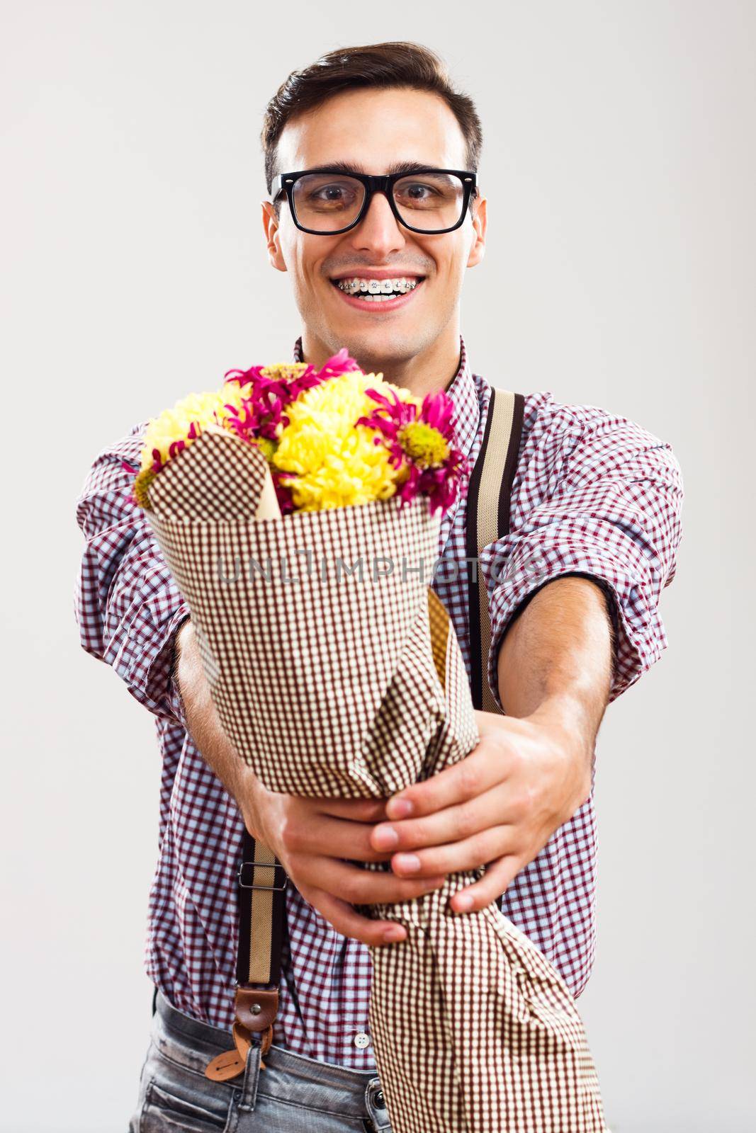 Portrait of nerdy man  holding  bouquet of flowers.