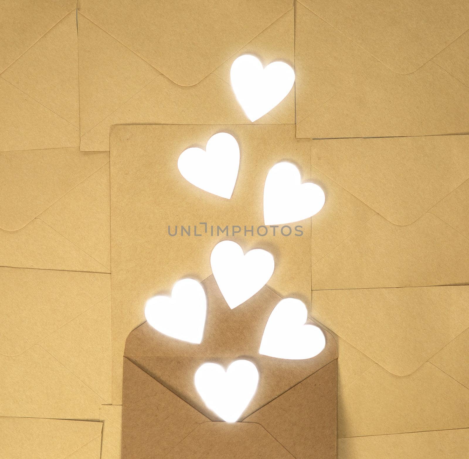Craft brown paper envelope with white hearts, Valentines Day, greeting card concept top view background, copy space romantic design