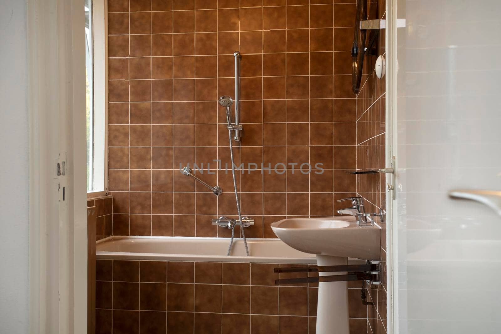 Architecture interior of a old vintage bathroom with brown tiles, Antique design, interior house concept see trough