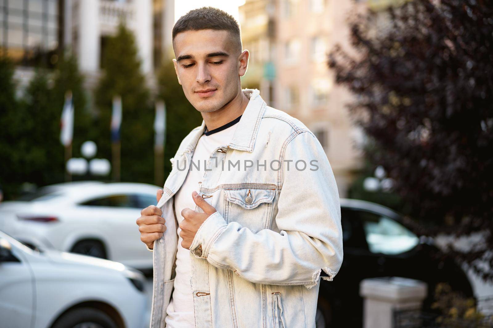 Portrait of handsome young casual man walking on the city street