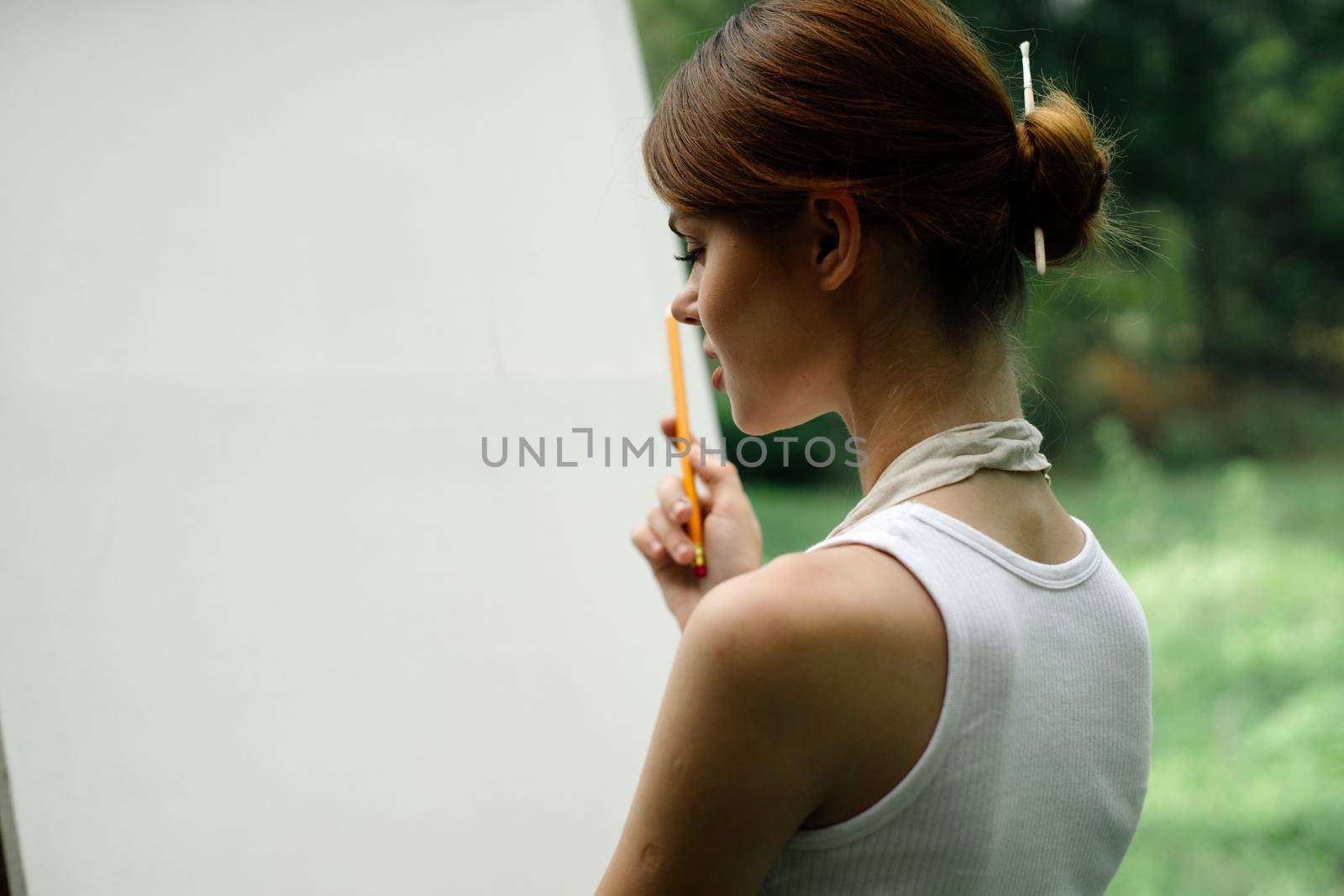 woman outdoors painting a picture creative art landscape. High quality photo