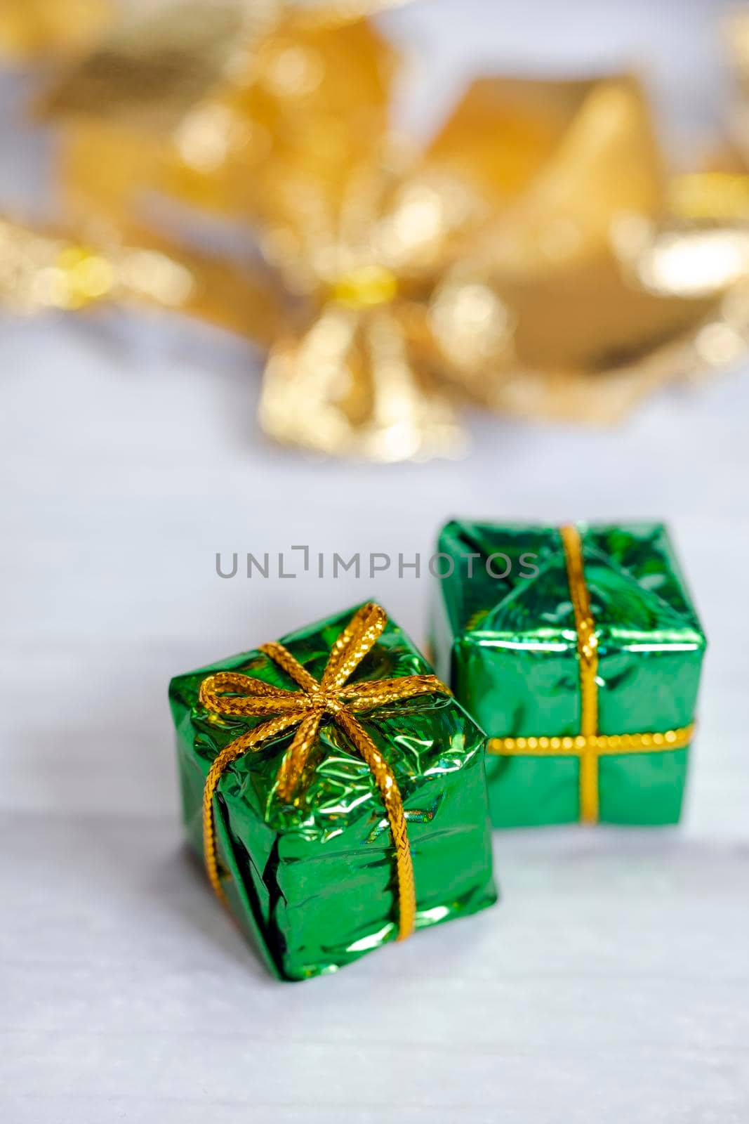 Pile of colored shiny gift boxes with copy space on white wood background,modern retro Christmas design, Colorful presents,Holiday concept space for text