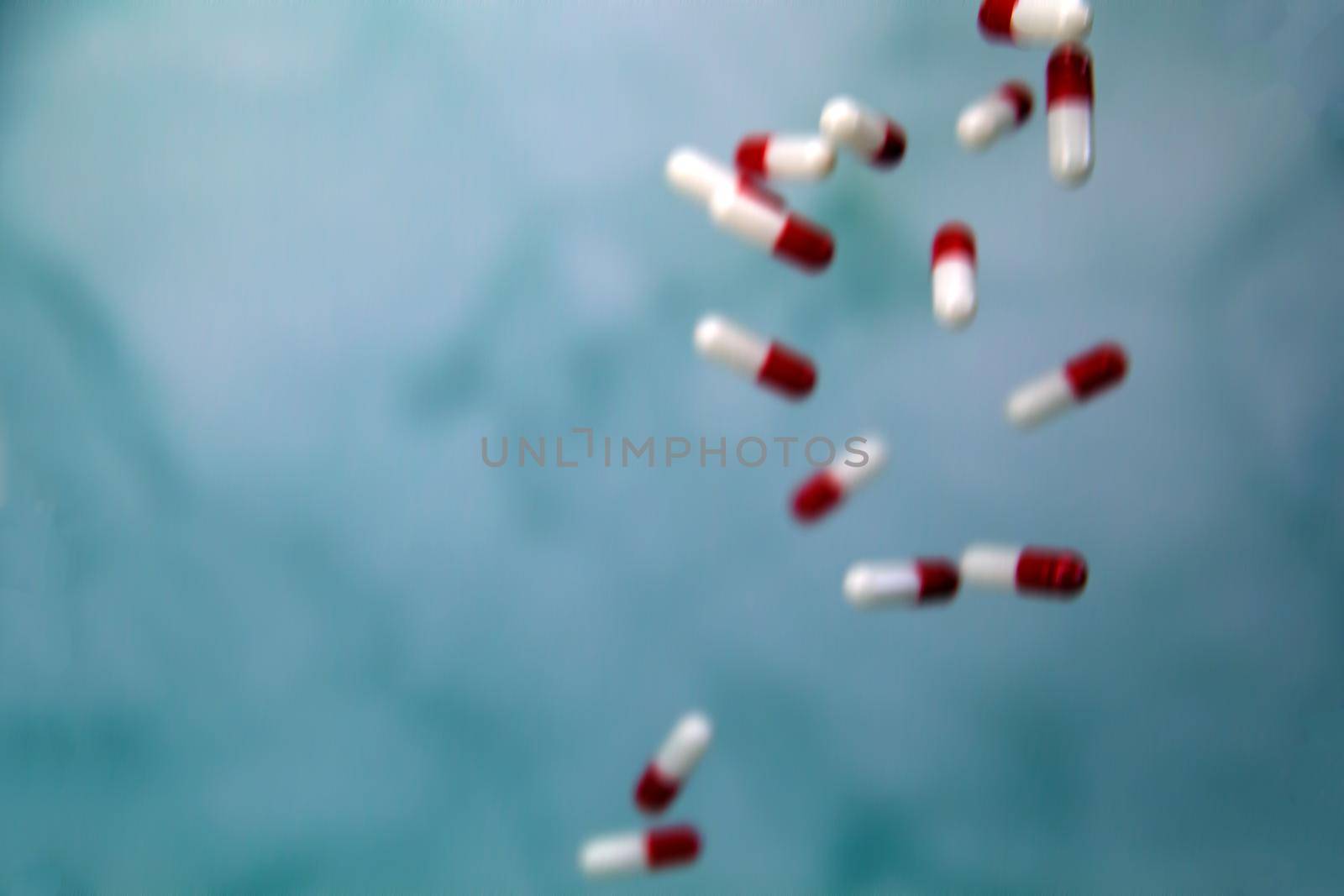 Falling medicine pills defocused blurred background, capsules for Health, Vitamin,drugs concept, copy space modern design space for text