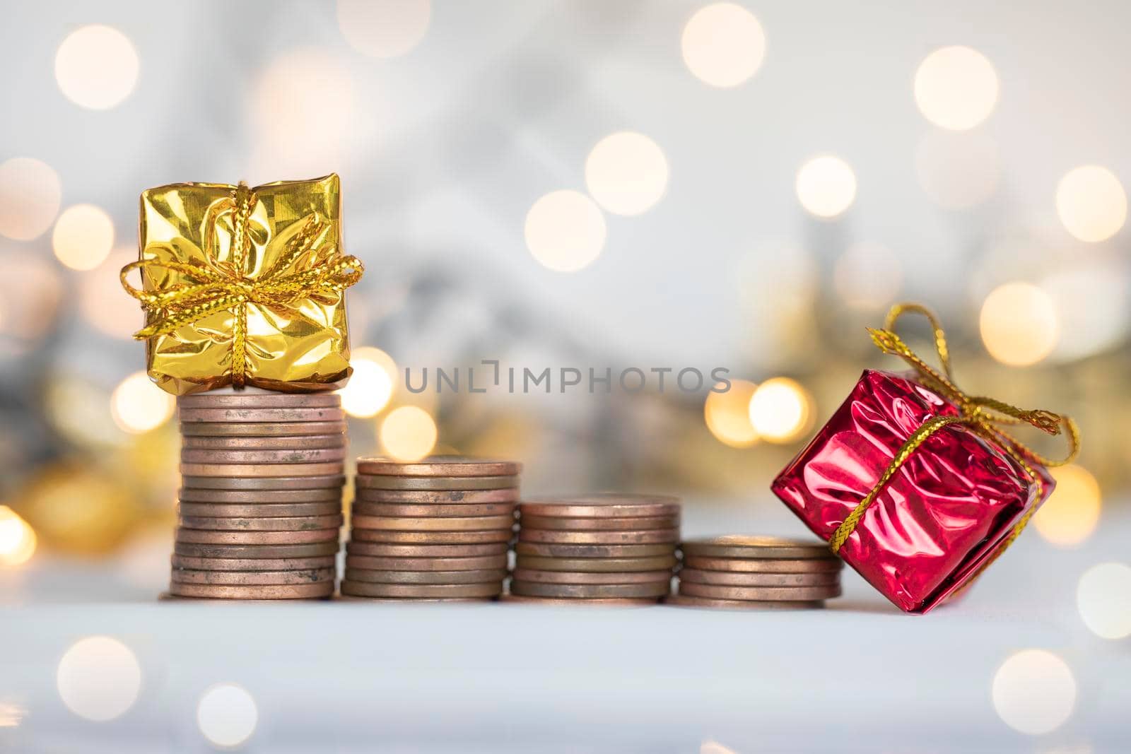 Coin climbing stairs with Christmas Holiday present, sparkling and shiny background, Finance,saving concept stacks of coins copy space