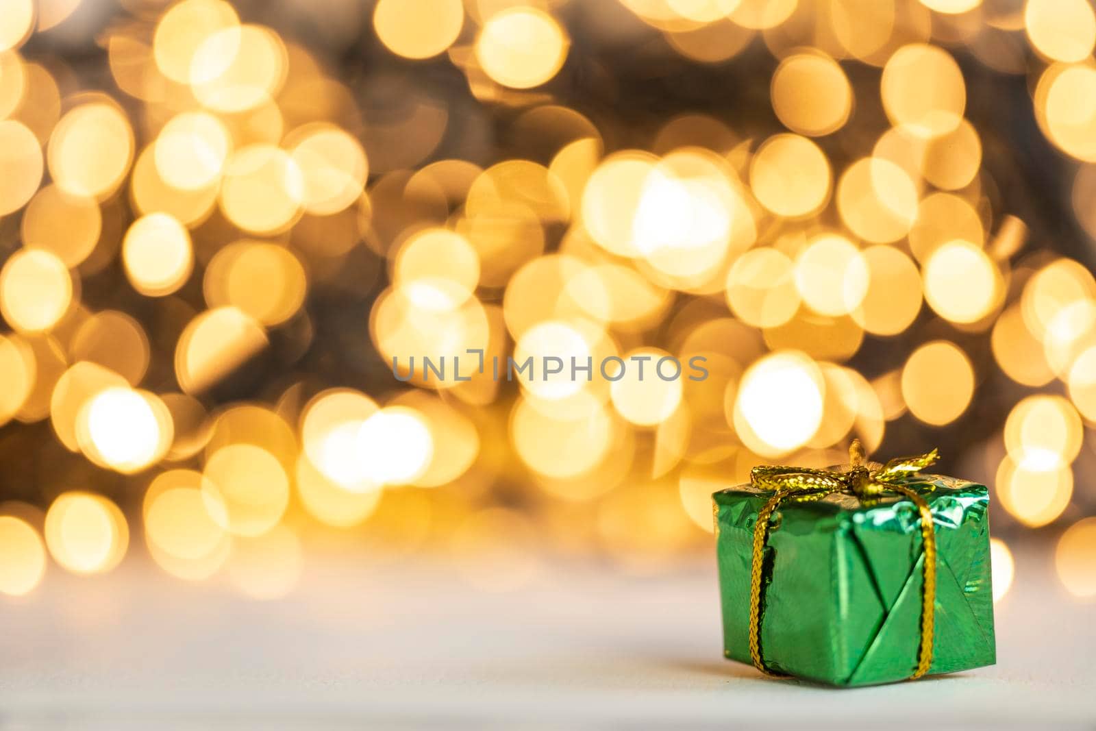 christmas present red and silver baubles against bokeh lights gold shiny glitter background with copy space, space for text