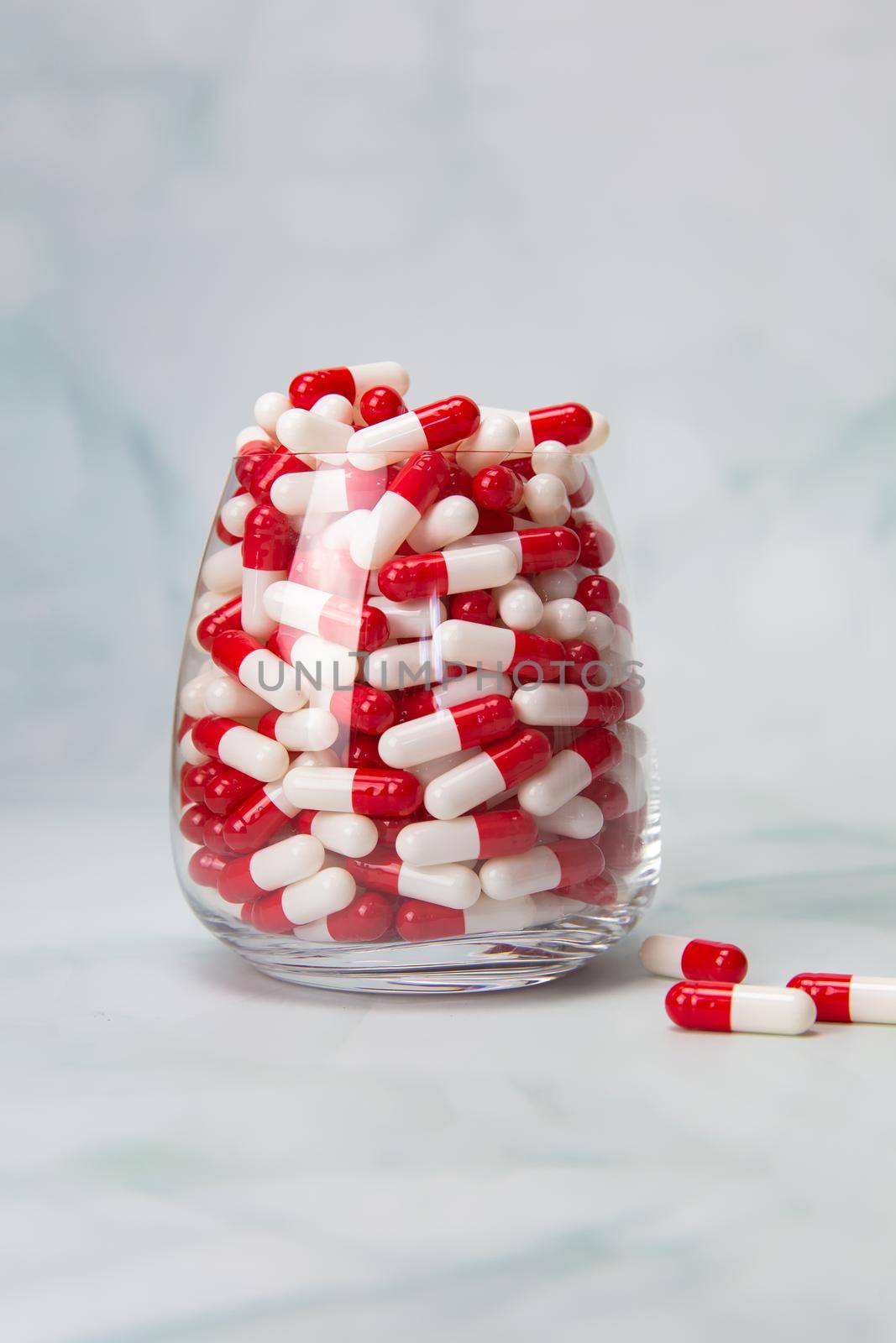 Filled glass with capsules pills for medication.drugs or vitamin,assorted pharmaceutical medicine tablets, in jar, health,business,medication concept with copy space space for text