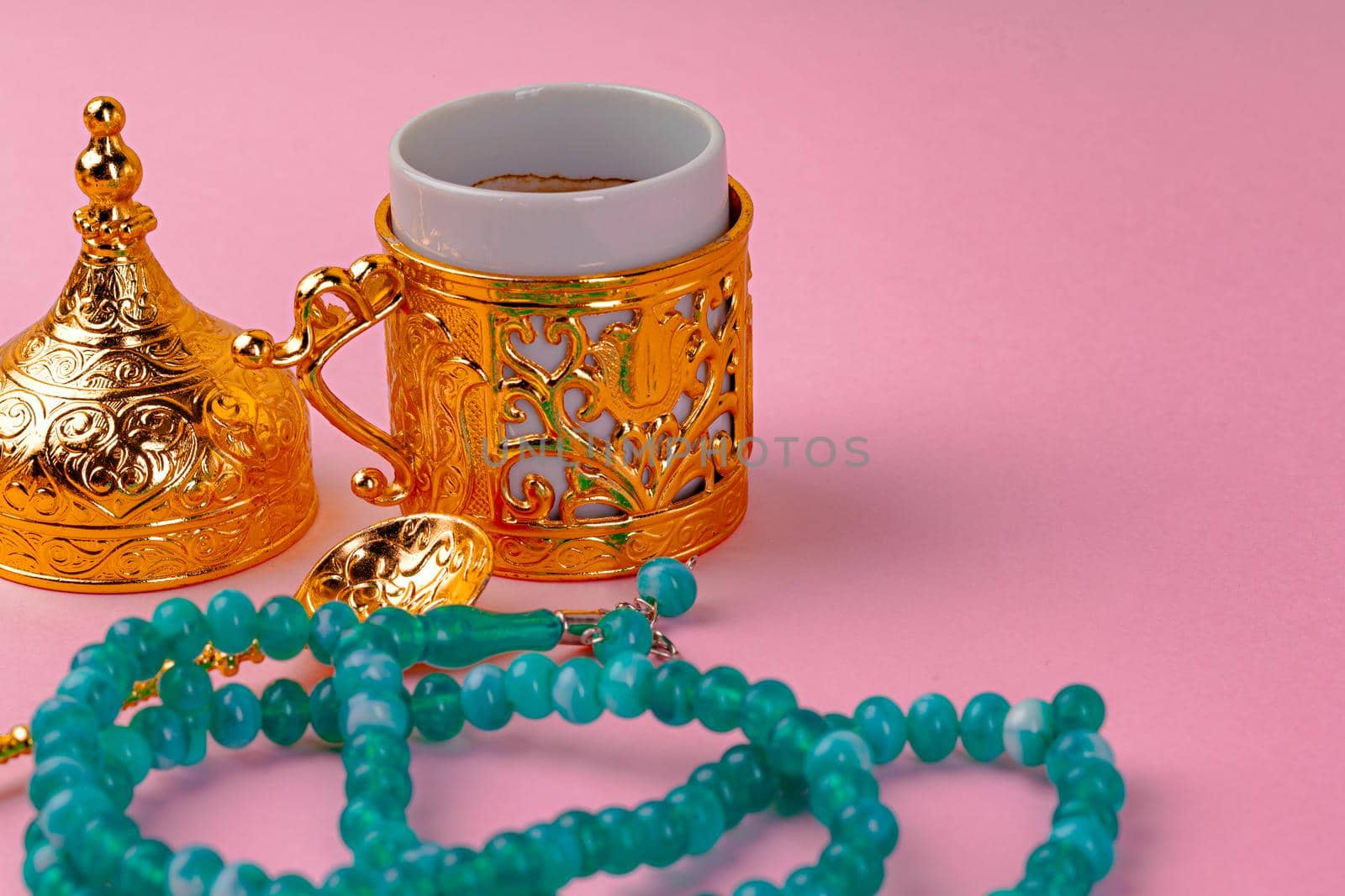 Cup of coffee and turkish dessert baklava on pink background