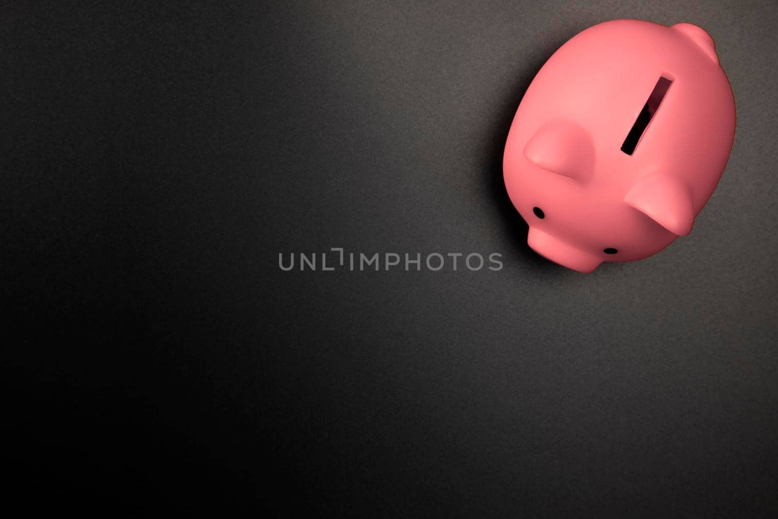 Pink Piggy Bank on a Black background top view with copy space.Savings,Financial and business concept space for text