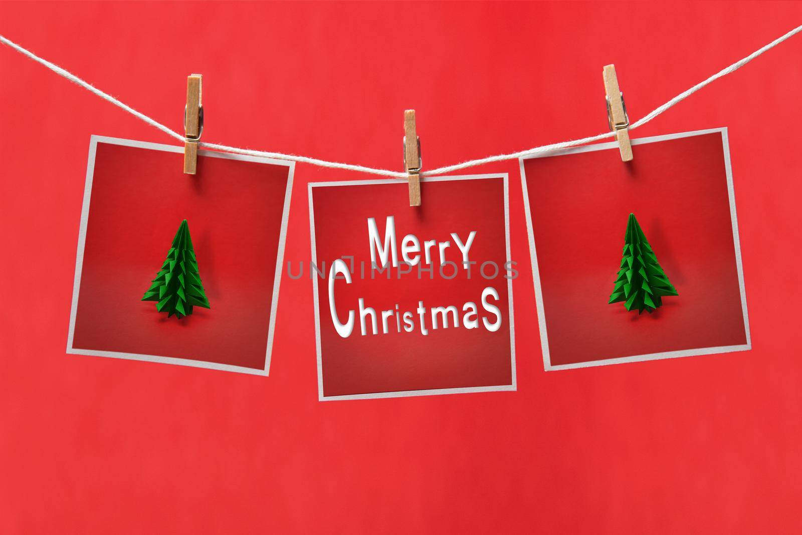Christmas cards on a clothespins on a red background