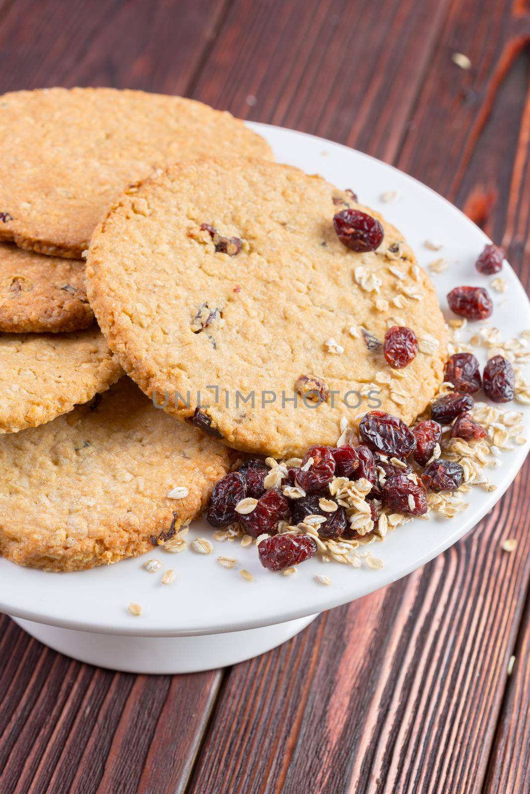 Oat cookies served on dark wooden table close up