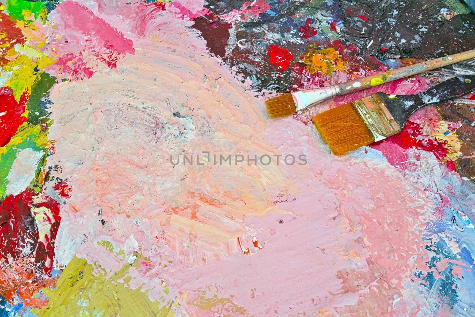 Various colors of paint with paint brushes, multi colored abstract oil paint stains background, bright colors painting copy space by Annebel146