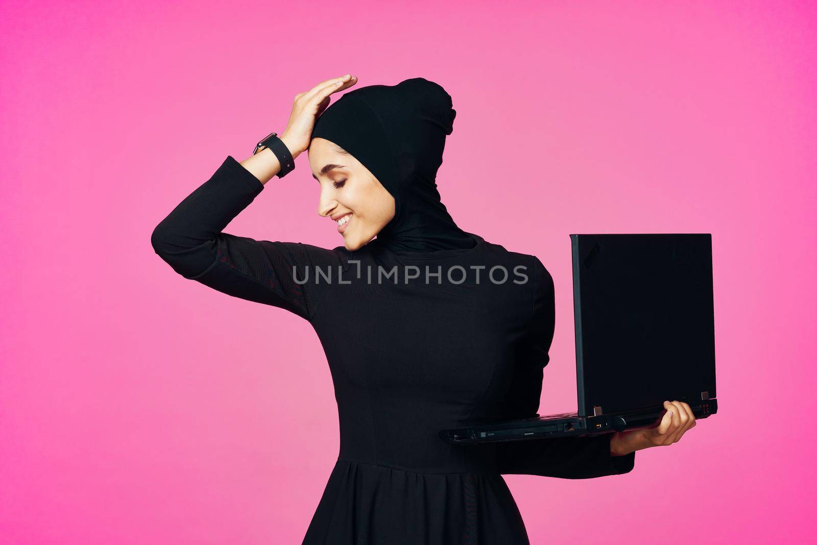 cheerful muslim woman with laptop education student internet technology. High quality photo
