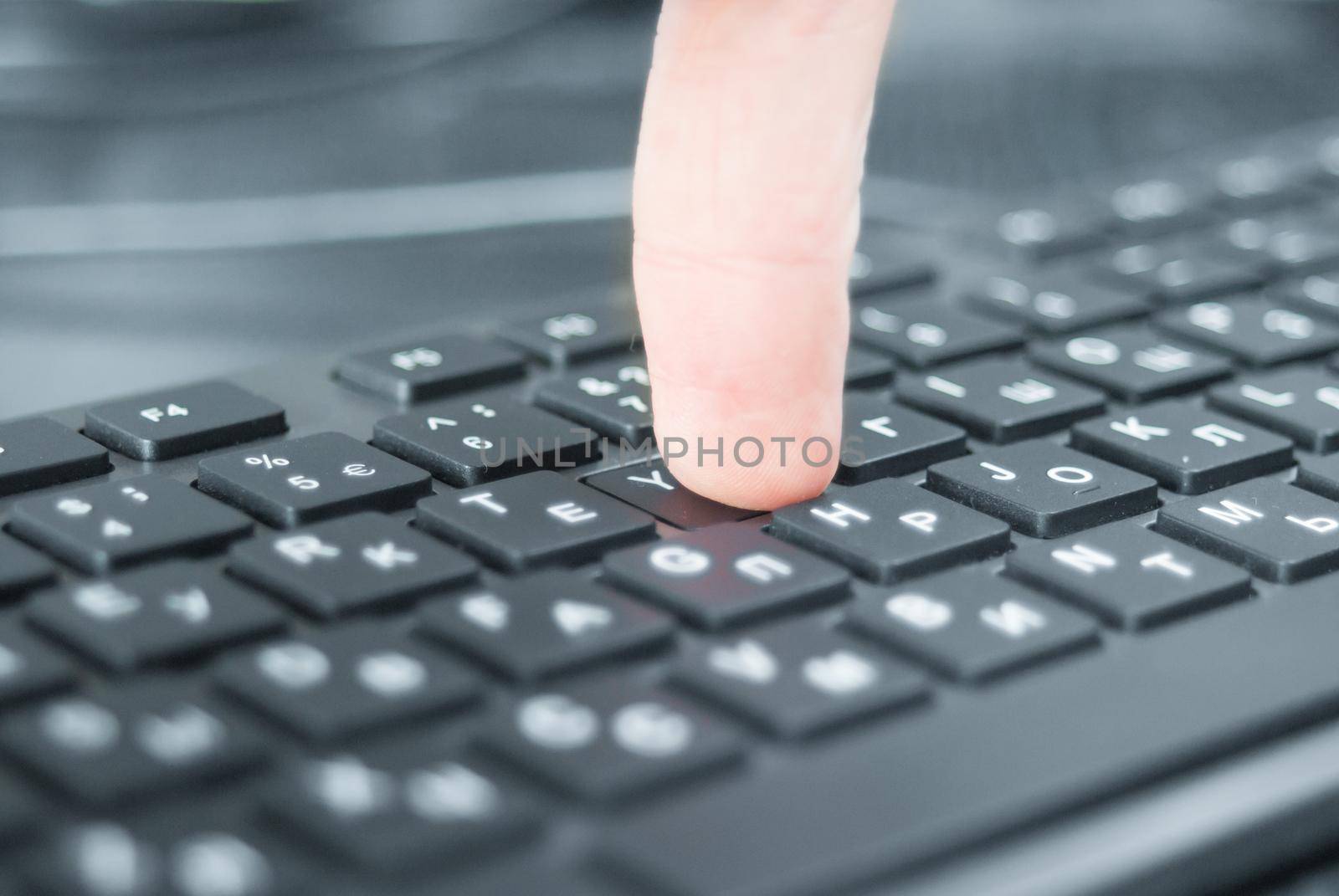 Pressing the keyboard closeup. Black keyboard on the desk