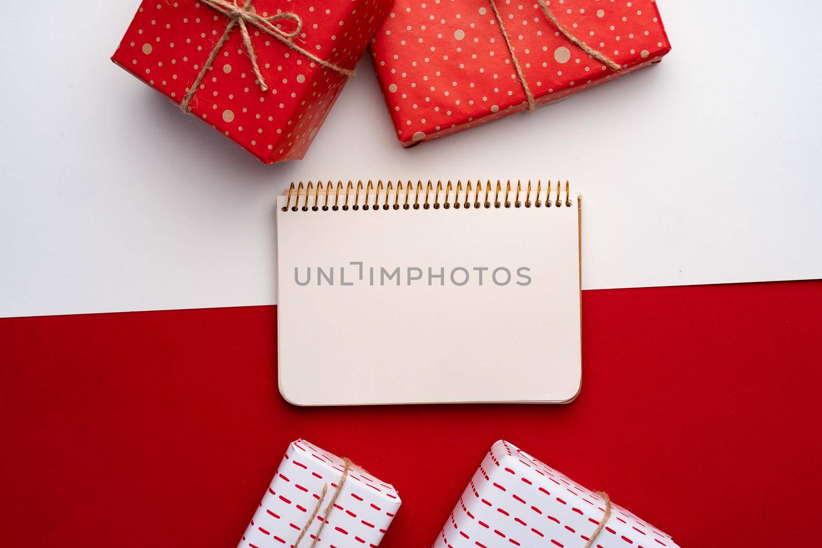 Beautiful red and white composition with Christmas gifts, view from above