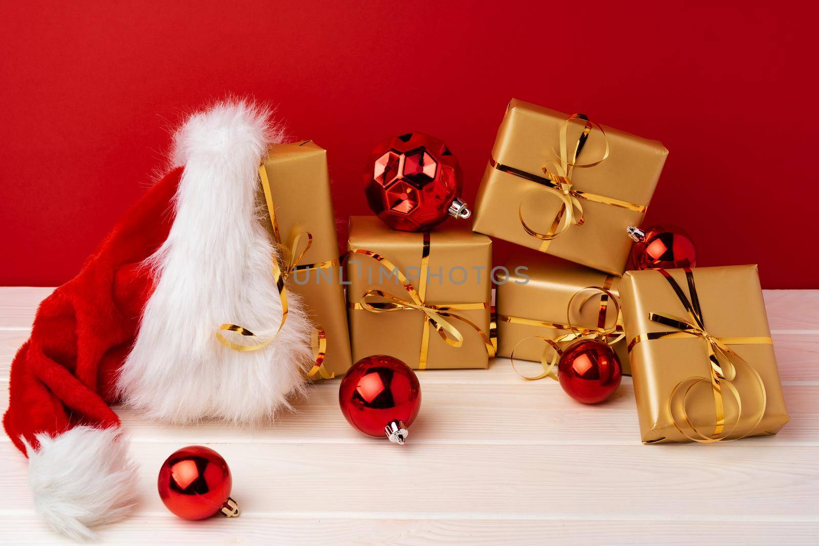 Wrapped christmas gift boxes against red background front view