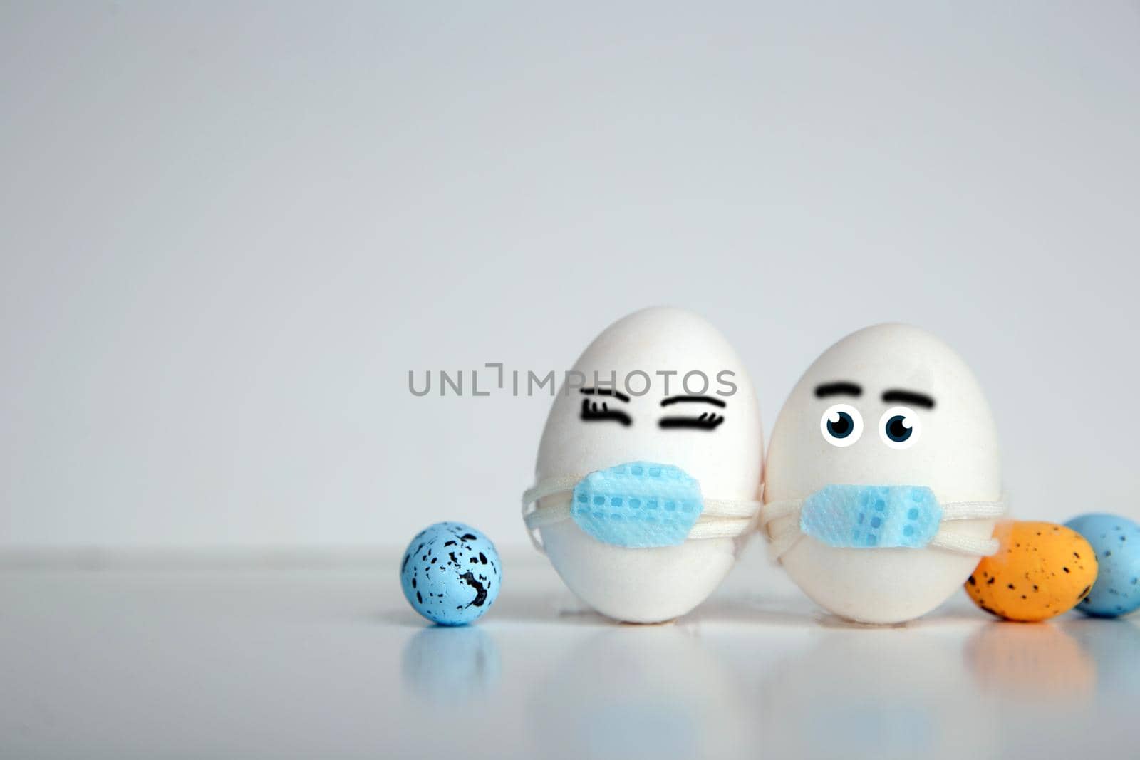 Easter eggs with Corona virus COVID19 protection concepts. DIY Do It Yourself easter eggs wearing mask for Easter holidays decoration on white background Selective focus with copy space. COVID-19 protection coronavirus