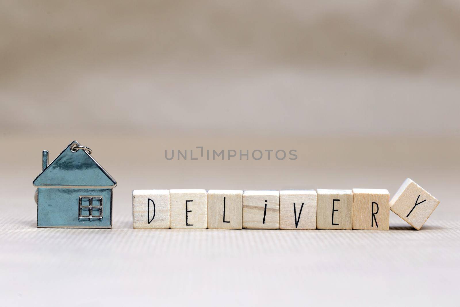 Home delivery text with wooden cubes and little miniature house on blurred background, Business, stay home for Covid-19, we deliver concept background copy space