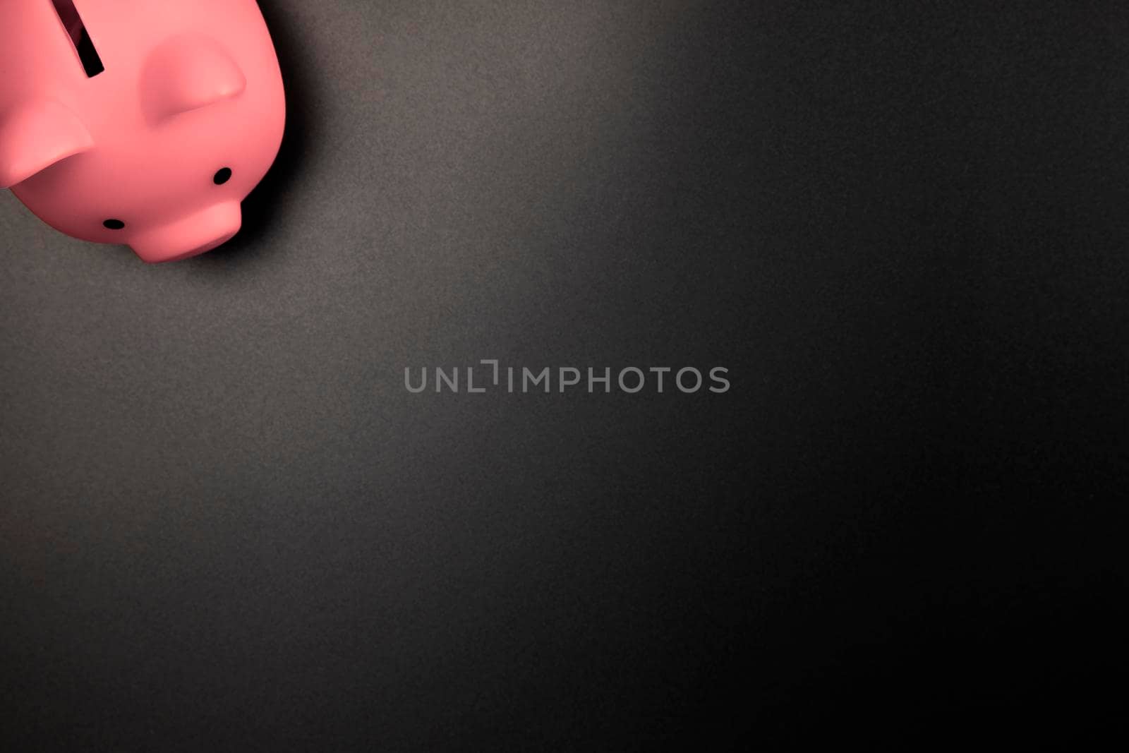 Pink Piggy Bank on a Black background top view with copy space.Savings,Financial and business concept space for text