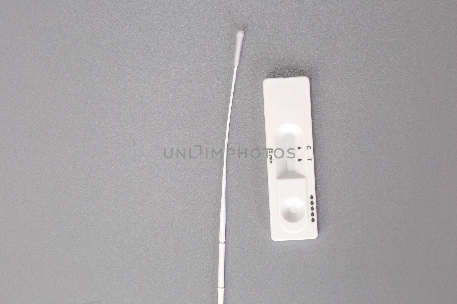 Rapid self test Covid-19 with nose swab, home test kit for coronavirus top view on gray background with copy space space for text