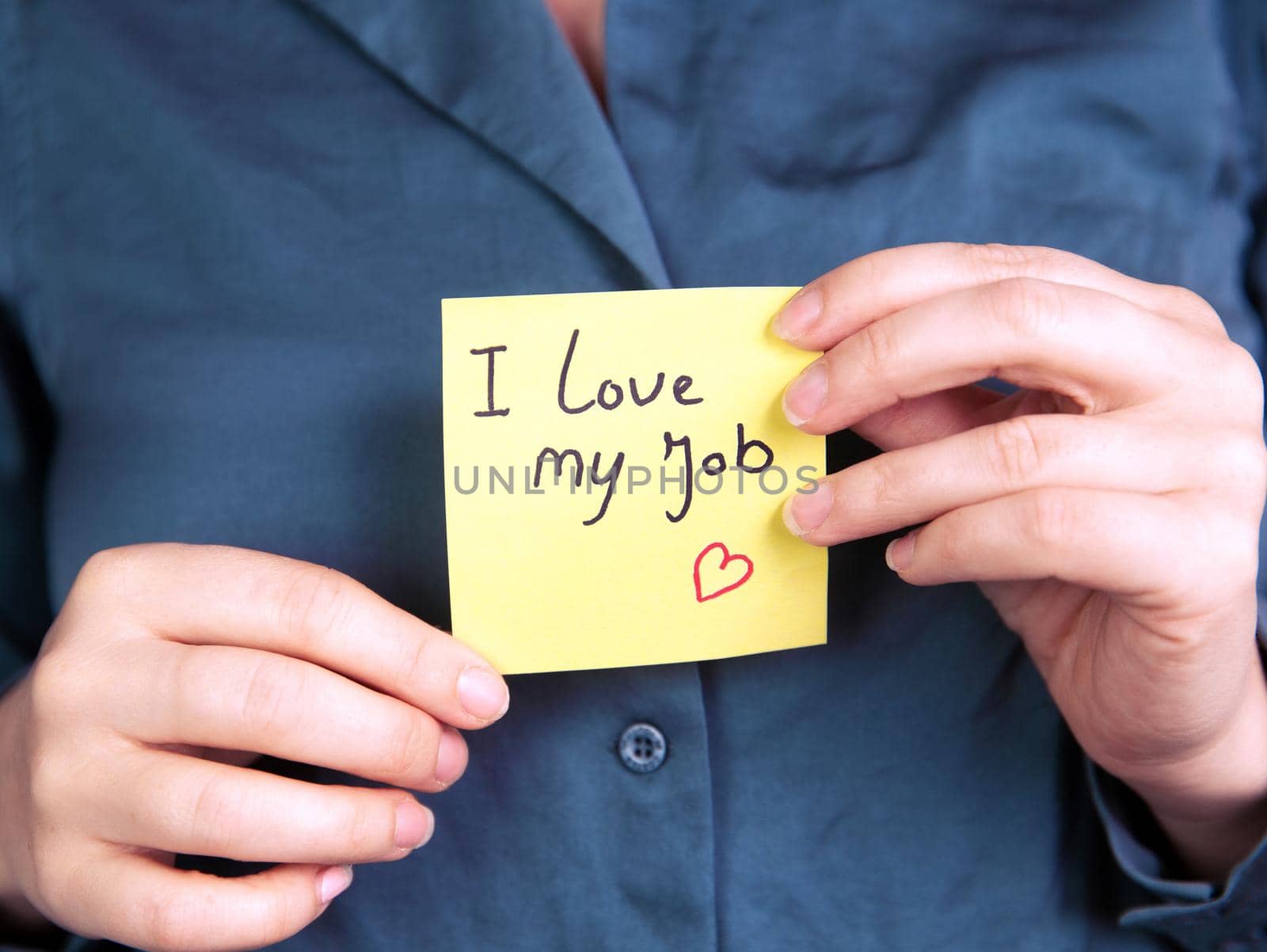I Love My Job Note in hand, business woman or man with yellow sticky note with positive achievement, business,goals,education,people concept close up