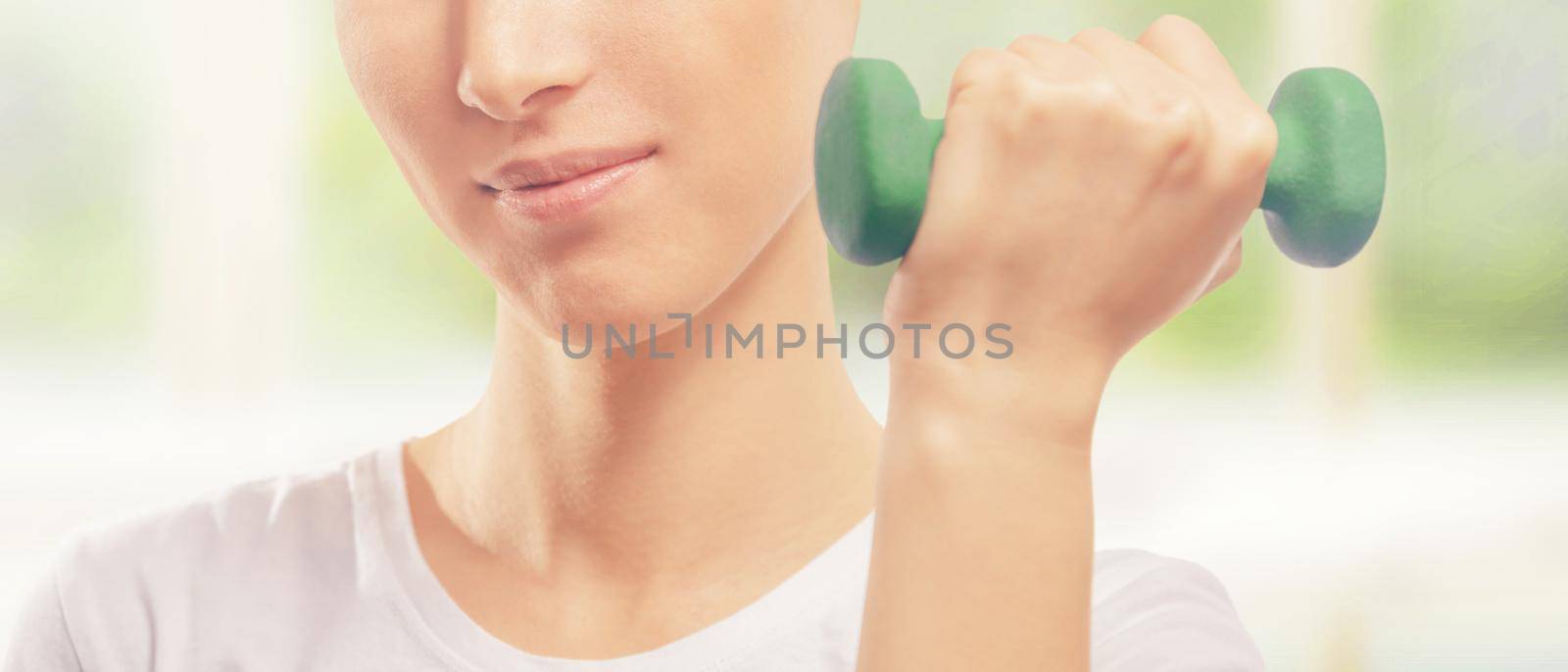 Woman is lifting dumbbell by alexAleksei