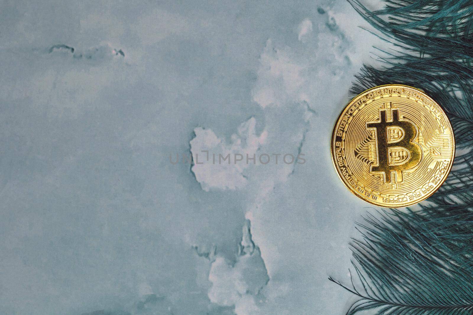 Golden Bitcoins Cryptocurrency top view stack of Digital coins on gray marble desk table green feathers background.Flat lay blank text.Copy space for word. concrete design