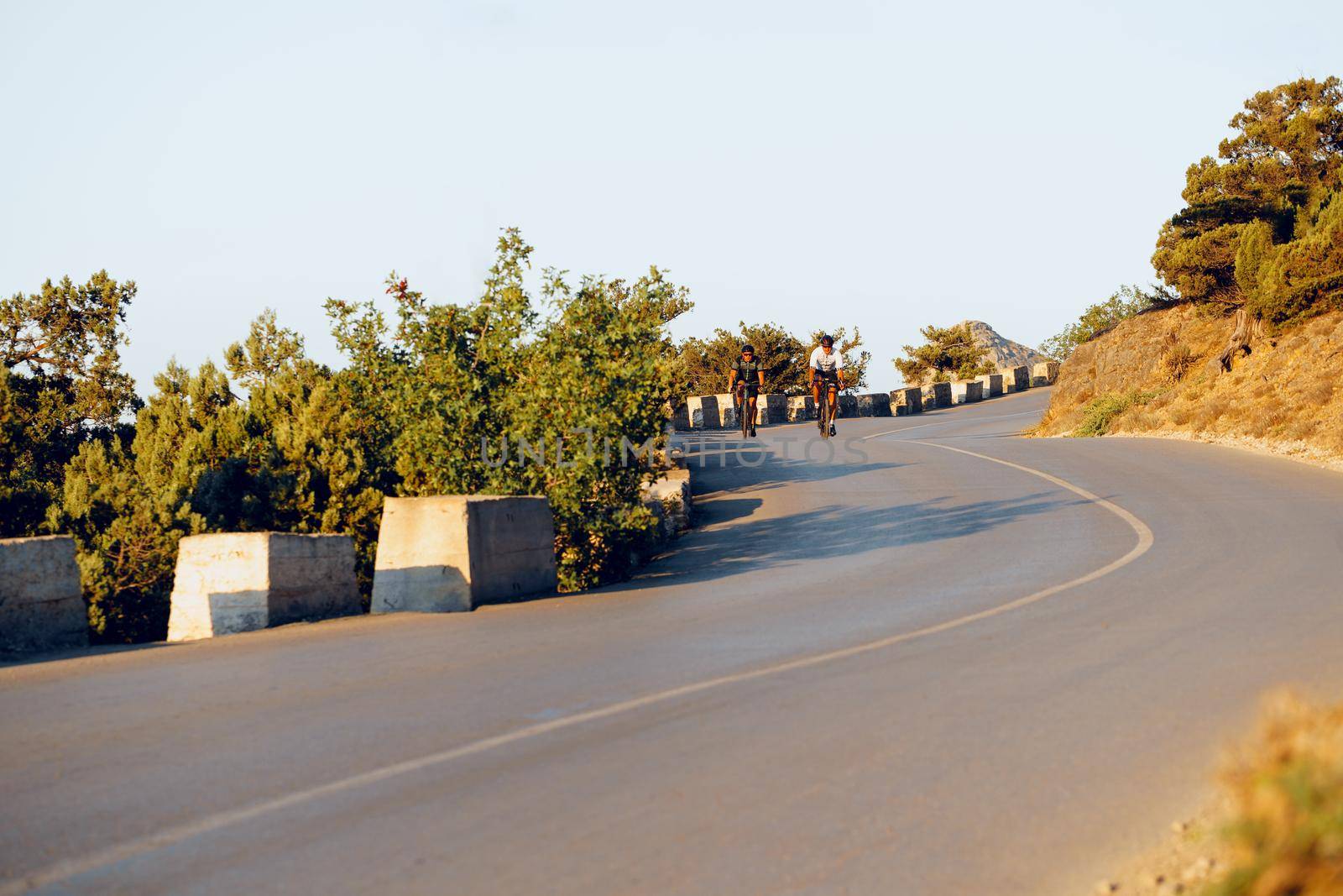 Cyclist riding on his bicycle at coastal road in the morning