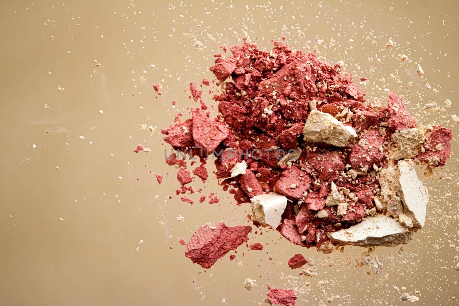 Crushed cosmetics, mineral organic eyeshadow, blush and cosmetic powder isolated on golden background, makeup and beauty banner, flatlay design.