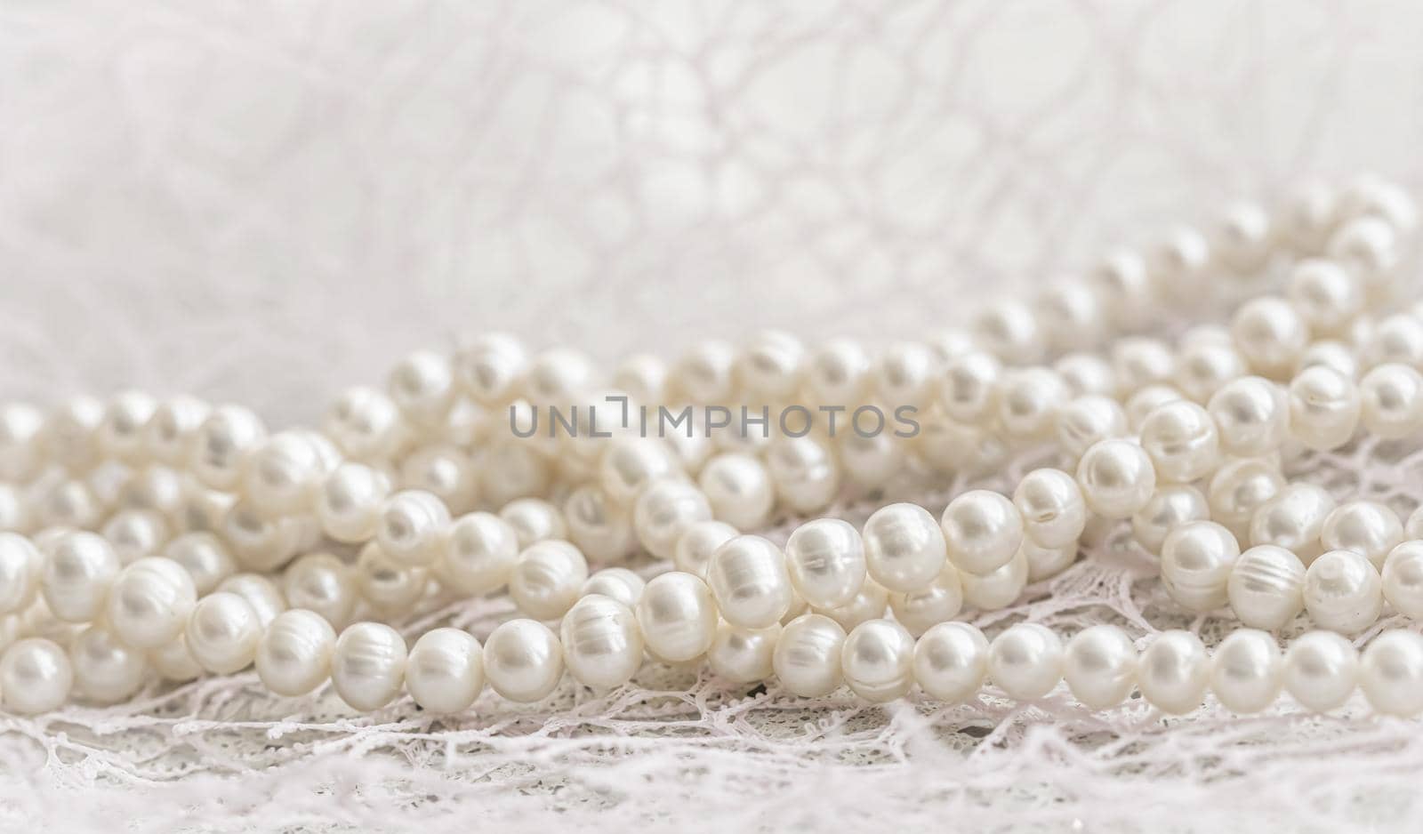 Nature white string of pearls in soft focus, with highlights.