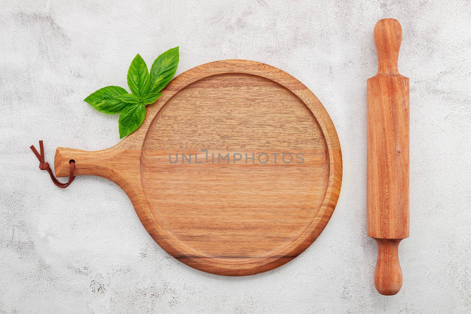 Empty wooden pizza platter set up on white concrete. Pizza tray on white concrete background flat lay and copy space.