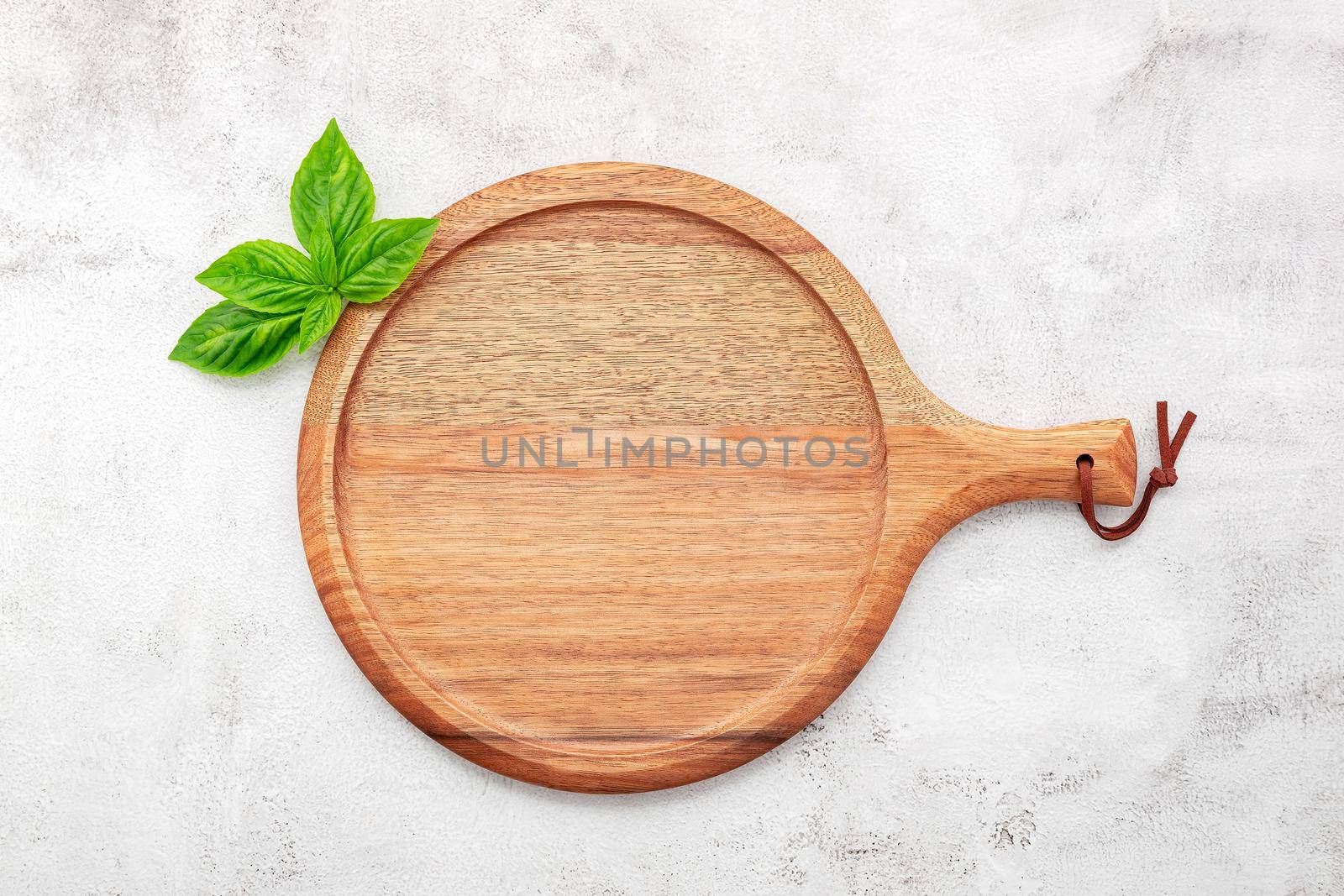Empty wooden pizza platter set up on white concrete. Pizza tray on white concrete background flat lay and copy space.
 by kerdkanno