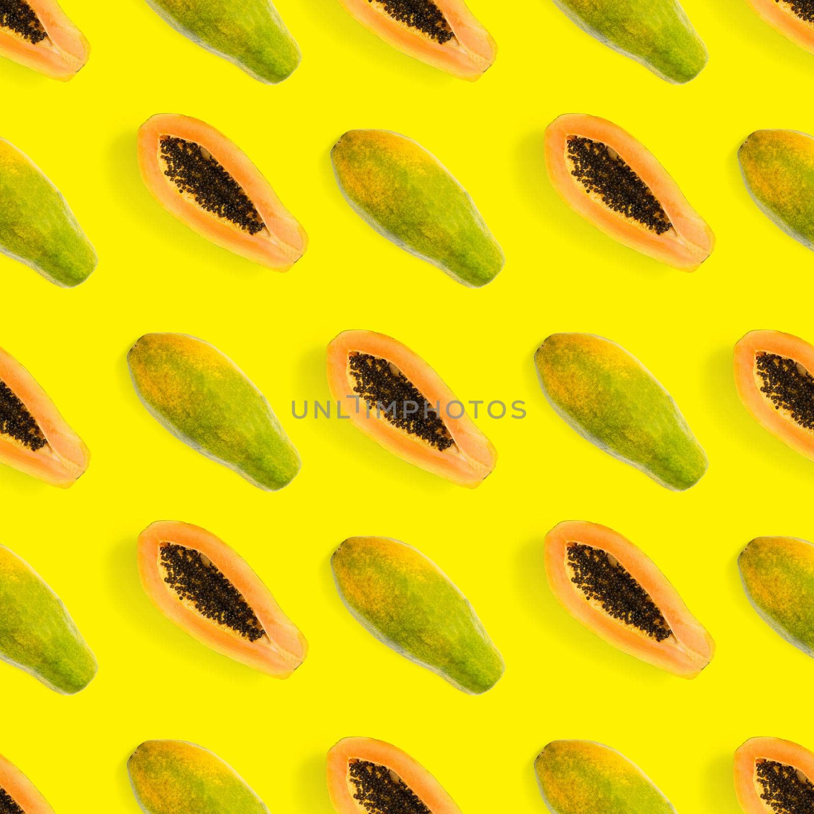 Fresh ripe papaya seamless pattern on yellow background. Tropical abstract background. Top view. by PhotoTime