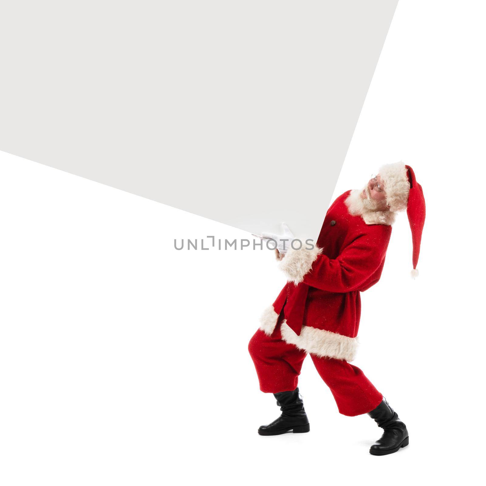 Santa Claus holding big heavy banner isolated on white background with copy space for text