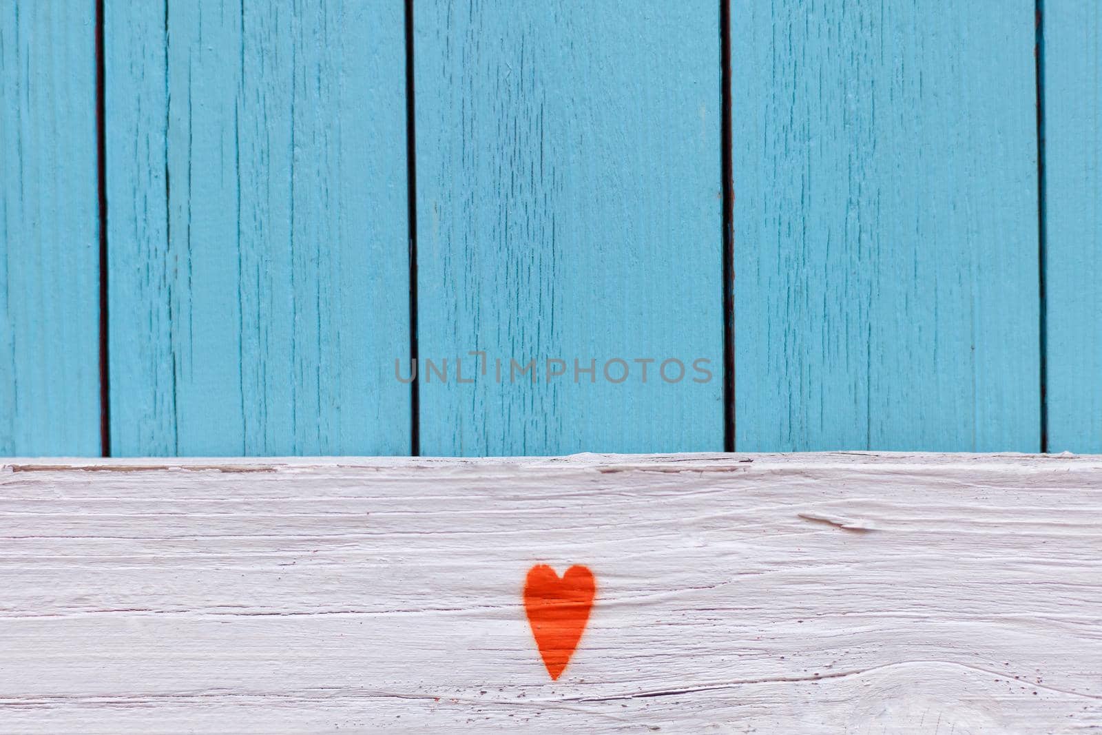 Orange heart painted on Distressed Vintage Boy Blue Grunge Wood Grain Texture Background. blue textured wooden wall. shabby wood