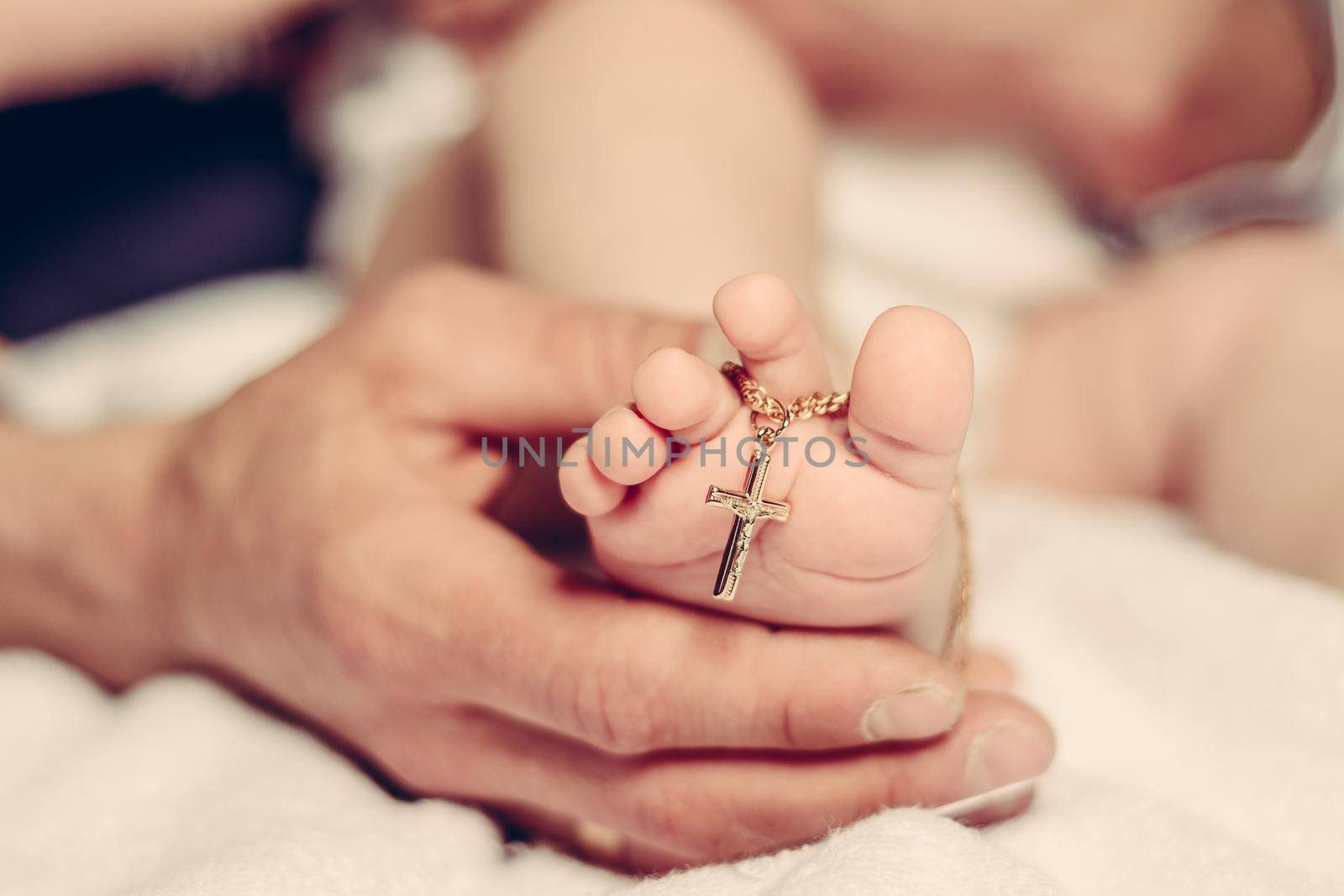 Baptism of a baby, close up of tiny baby feet, sacrament of baptism. by Niko_Cingaryuk