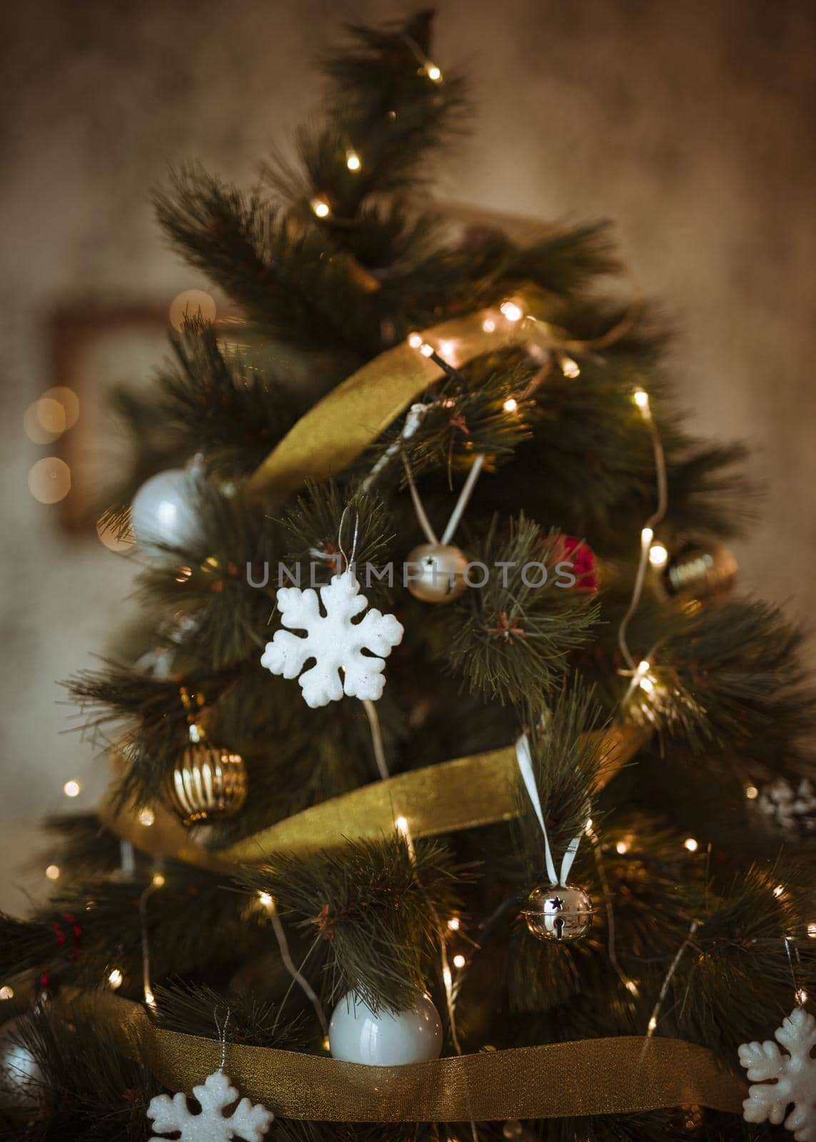 christmas tree decorated with golden white ornaments