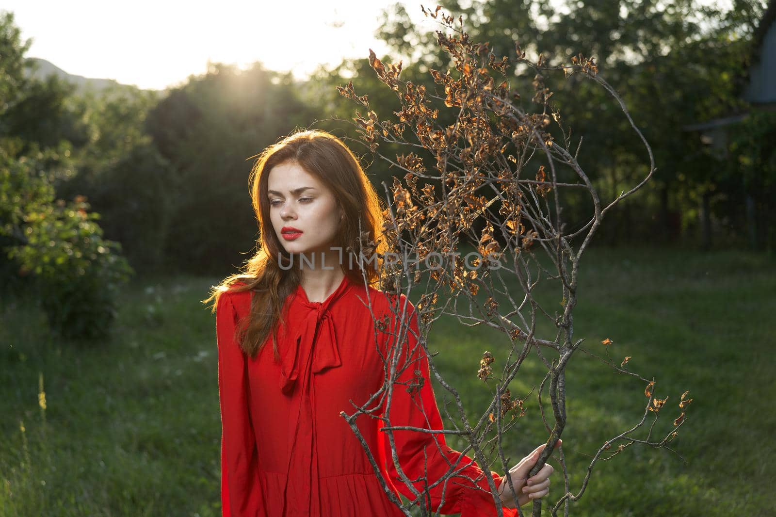 attractive woman in red dress outdoors fresh air summer. High quality photo