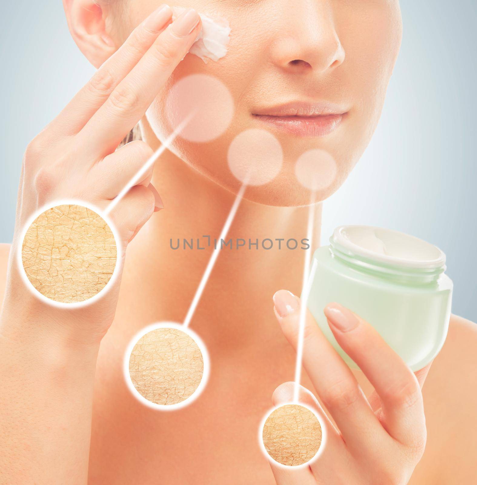 Woman applies moisturizer cream on face, concept of skincare, in circles dry skin before cream