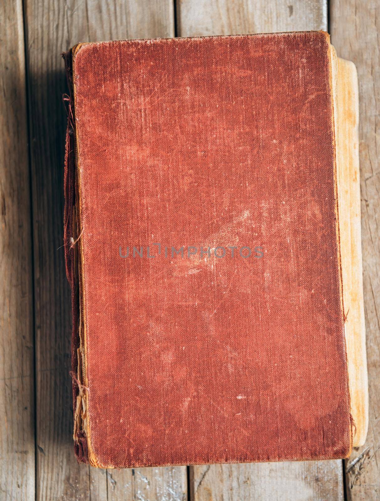 Vintage red book on a wooden table, space for text