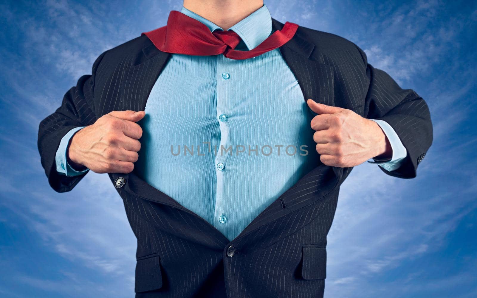 Businessman opens jacket showing his shirt on background of sky, face is not visible