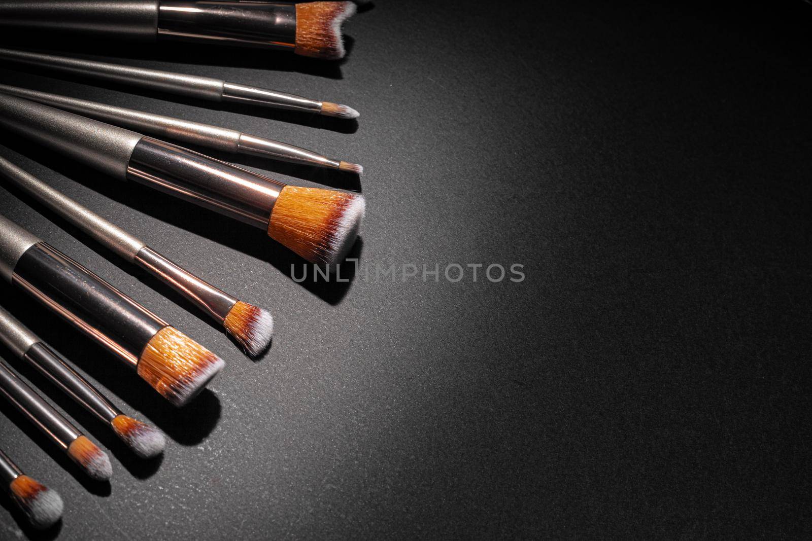 Collection of make up brushes on black background, close up