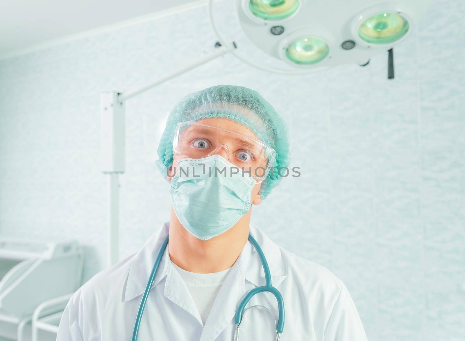 Portrait of man crazy doctor surgeon in a hospital